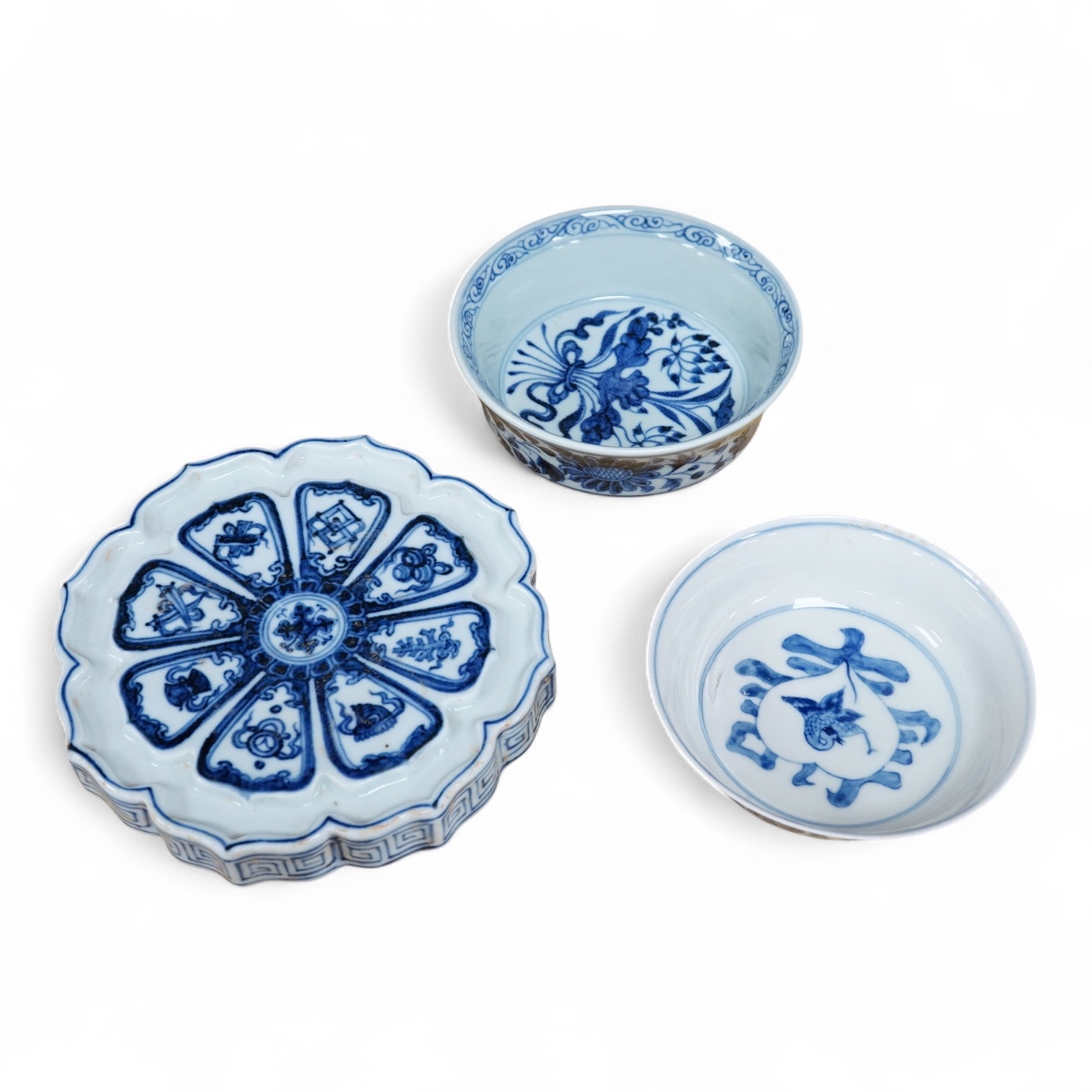 Two Chinese blue and white bowls and a lotus shaped tea pot stand, largest 15cm in diameter